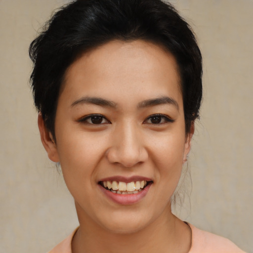 Joyful latino young-adult female with short  black hair and brown eyes