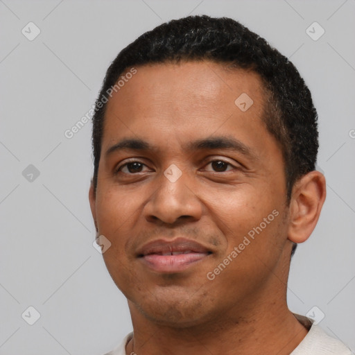 Joyful black young-adult male with short  black hair and brown eyes