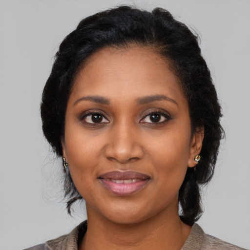 Joyful black young-adult female with medium  black hair and brown eyes