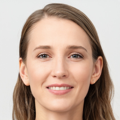 Joyful white young-adult female with long  brown hair and grey eyes