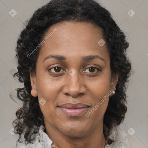 Joyful black adult female with medium  brown hair and brown eyes