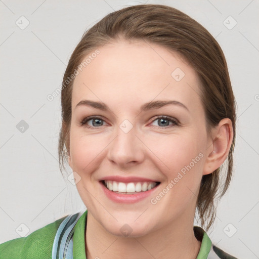 Joyful white young-adult female with medium  brown hair and blue eyes