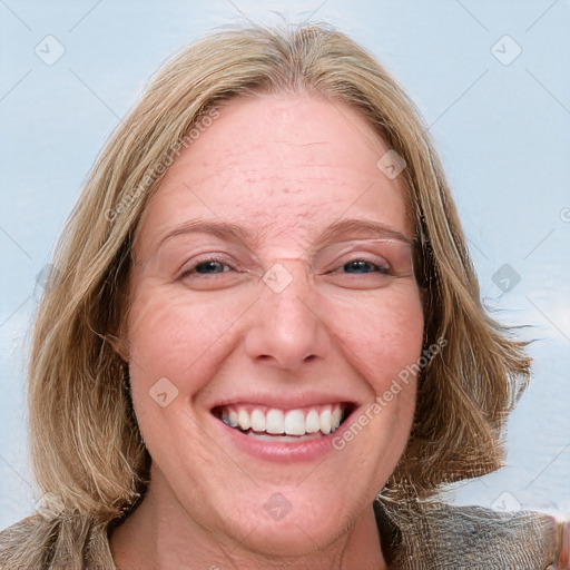 Joyful white adult female with medium  brown hair and blue eyes