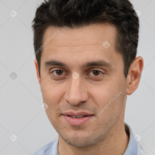 Joyful white adult male with short  brown hair and brown eyes