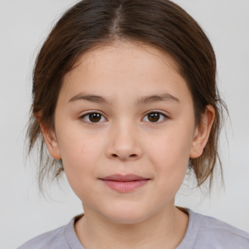 Joyful white child female with medium  brown hair and brown eyes