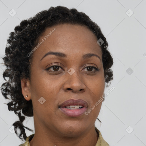 Joyful black adult female with long  brown hair and brown eyes