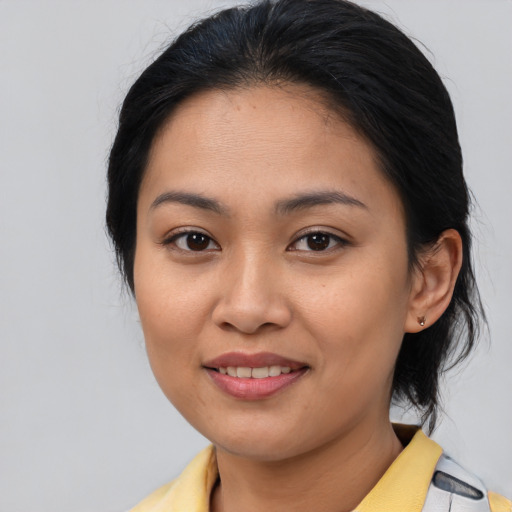 Joyful asian young-adult female with medium  brown hair and brown eyes