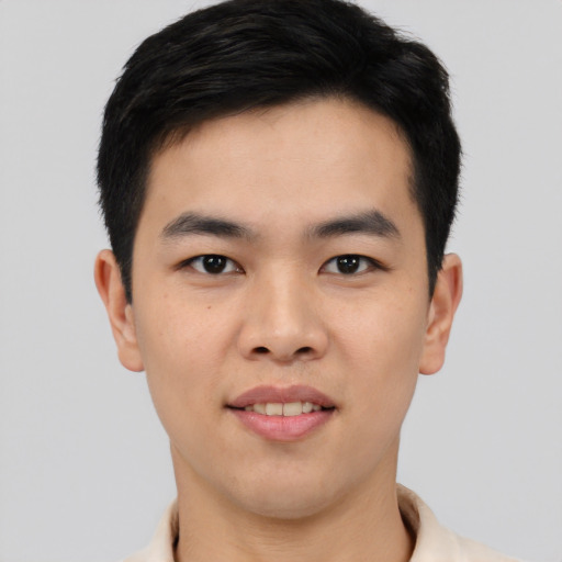 Joyful asian young-adult male with short  black hair and brown eyes
