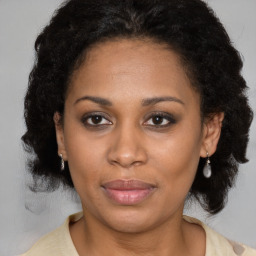 Joyful latino adult female with medium  brown hair and brown eyes