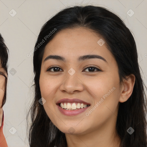 Joyful latino young-adult female with long  brown hair and brown eyes