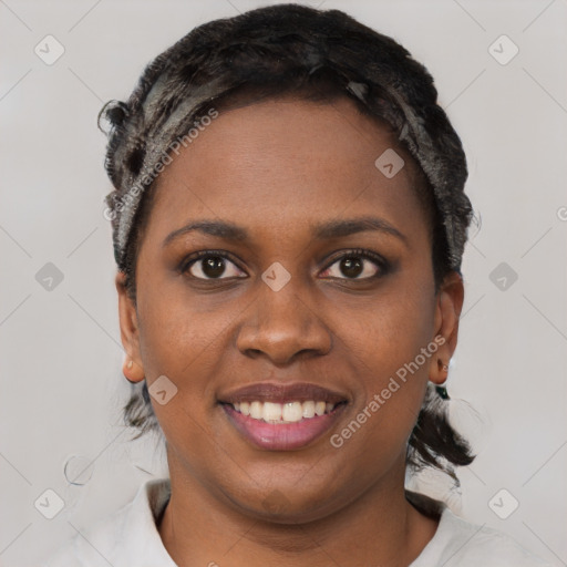 Joyful black young-adult female with short  black hair and brown eyes