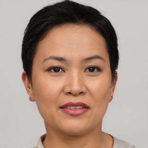 Joyful asian adult female with short  brown hair and brown eyes