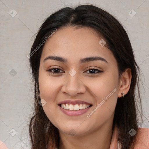 Joyful latino young-adult female with medium  brown hair and brown eyes