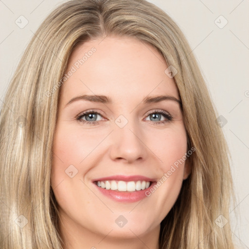 Joyful white young-adult female with long  brown hair and brown eyes