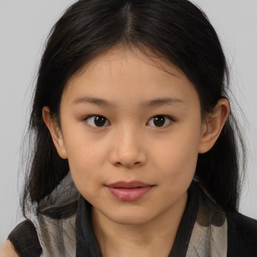 Joyful asian child female with medium  brown hair and brown eyes