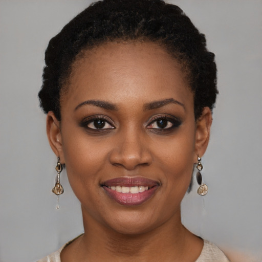 Joyful black young-adult female with short  black hair and brown eyes