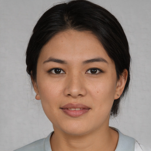 Joyful asian young-adult female with medium  black hair and brown eyes