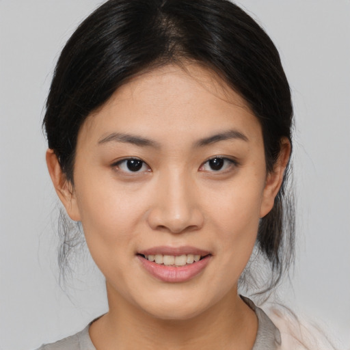 Joyful asian young-adult female with medium  brown hair and brown eyes