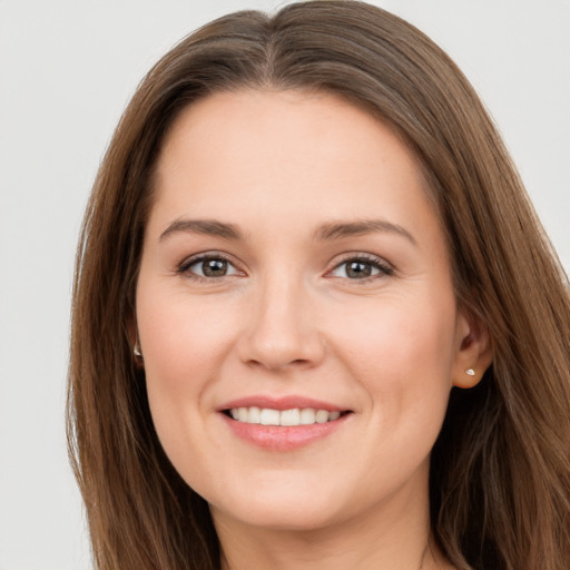 Joyful white young-adult female with long  brown hair and brown eyes