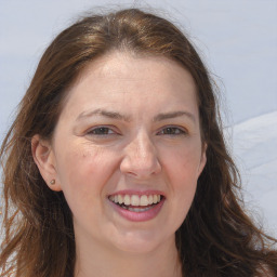 Joyful white adult female with long  brown hair and brown eyes