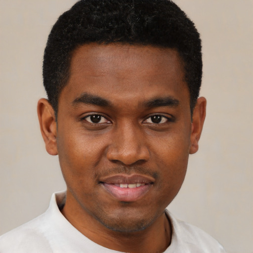 Joyful black young-adult male with short  black hair and brown eyes