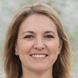 Joyful white adult female with medium  brown hair and brown eyes