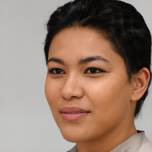 Joyful asian young-adult female with short  black hair and brown eyes
