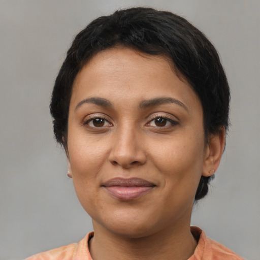 Joyful latino adult female with medium  brown hair and brown eyes