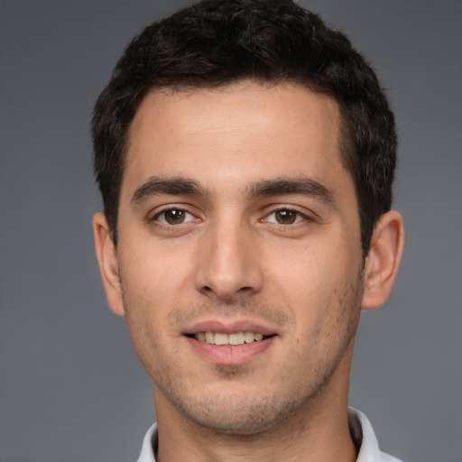 Joyful white young-adult male with short  brown hair and brown eyes
