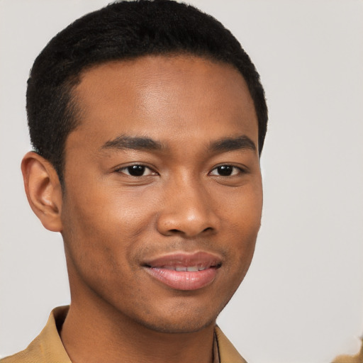 Joyful black young-adult male with short  brown hair and brown eyes