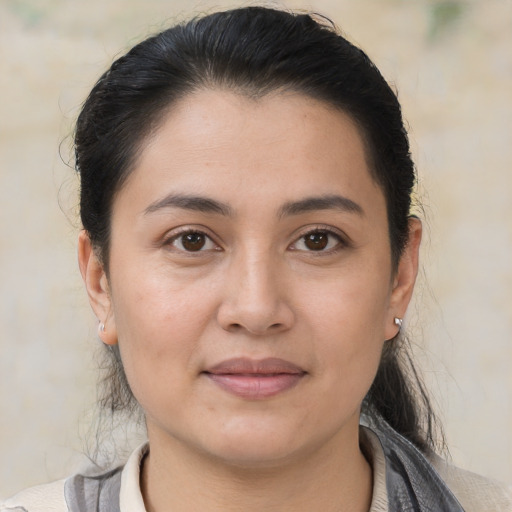 Joyful white young-adult female with medium  brown hair and brown eyes