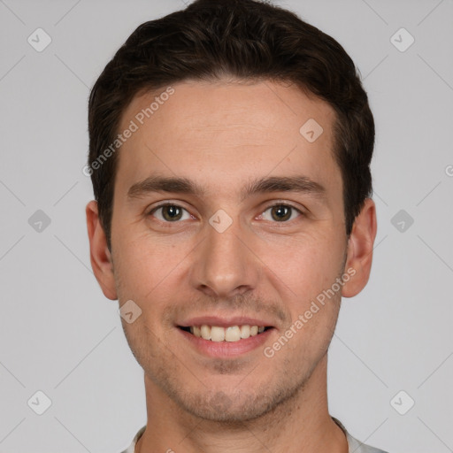 Joyful white young-adult male with short  brown hair and grey eyes