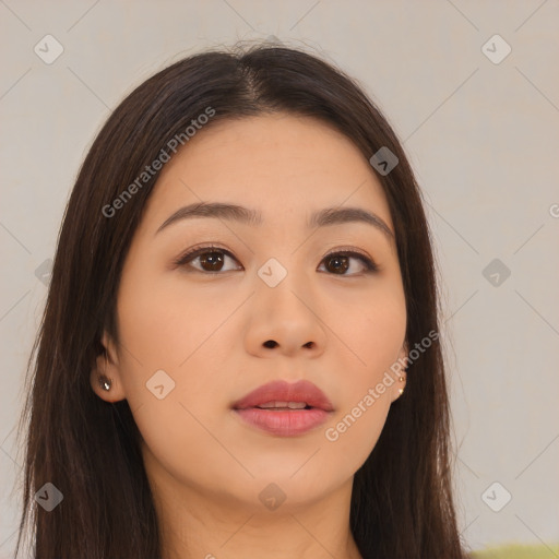 Joyful asian young-adult female with long  brown hair and brown eyes