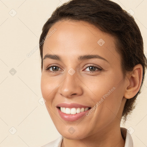 Joyful white young-adult female with long  brown hair and brown eyes