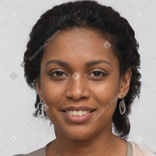 Joyful black young-adult female with long  black hair and brown eyes