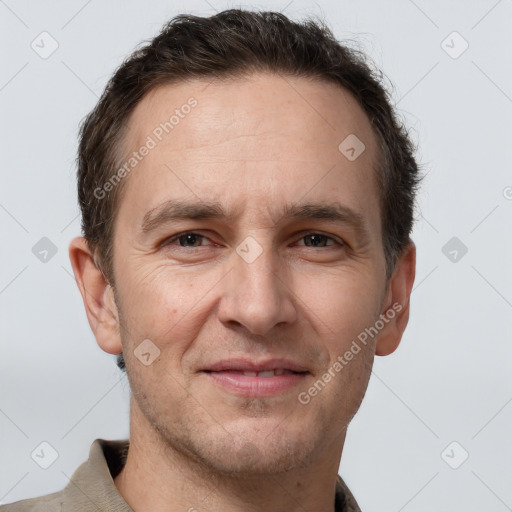 Joyful white adult male with short  brown hair and grey eyes