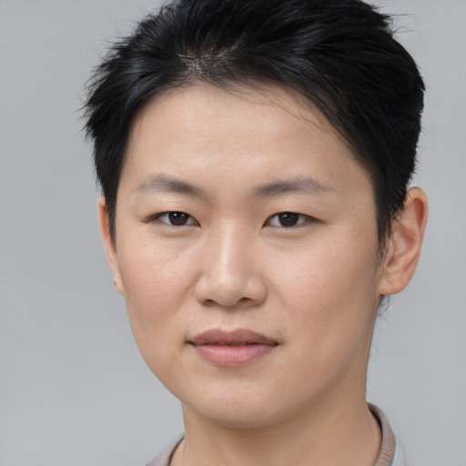 Joyful asian young-adult female with short  brown hair and brown eyes