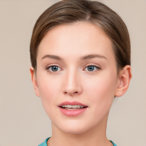 Joyful white young-adult female with short  brown hair and blue eyes