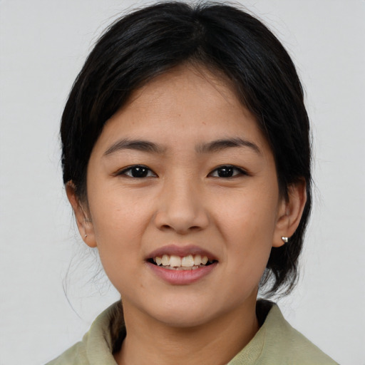 Joyful asian young-adult female with medium  brown hair and brown eyes