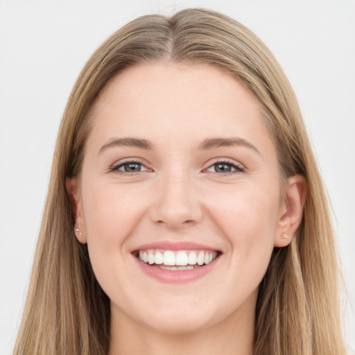 Joyful white young-adult female with long  brown hair and grey eyes