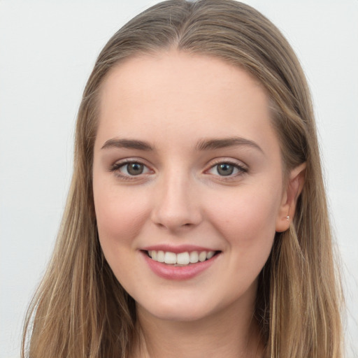 Joyful white young-adult female with long  brown hair and grey eyes