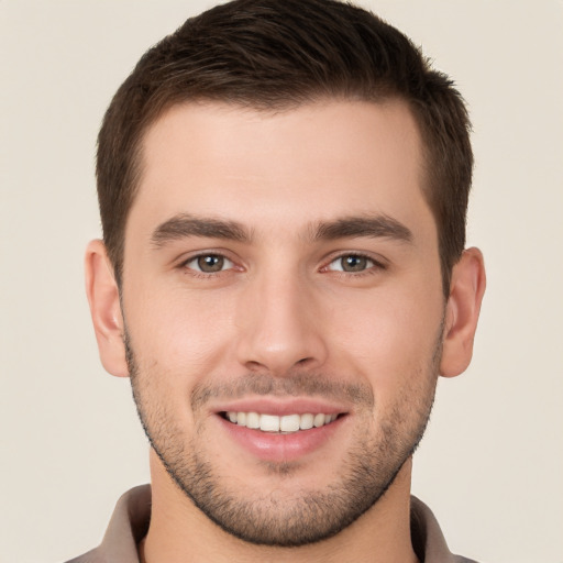 Joyful white young-adult male with short  brown hair and brown eyes