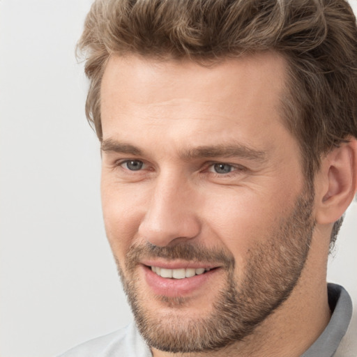 Joyful white adult male with short  brown hair and brown eyes