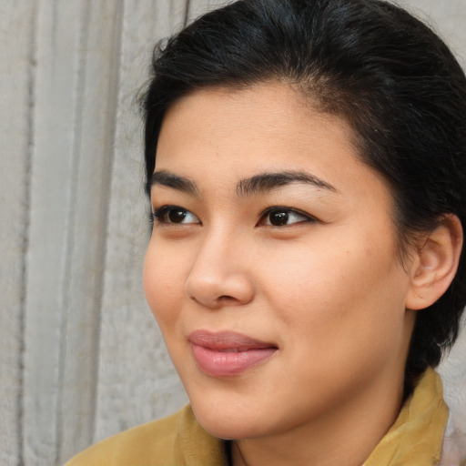 Joyful asian young-adult female with medium  brown hair and brown eyes