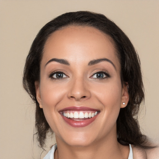 Joyful white young-adult female with medium  brown hair and brown eyes