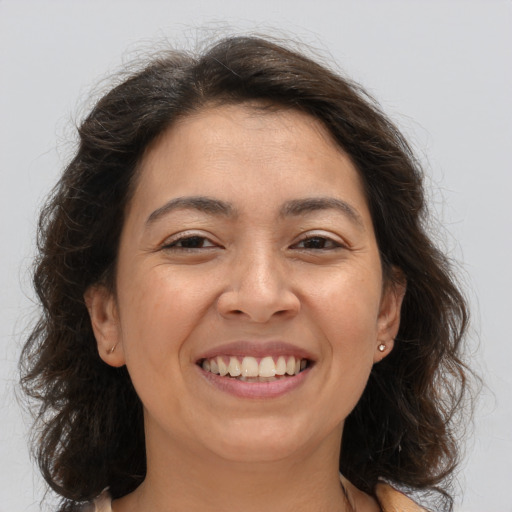 Joyful white adult female with medium  brown hair and brown eyes