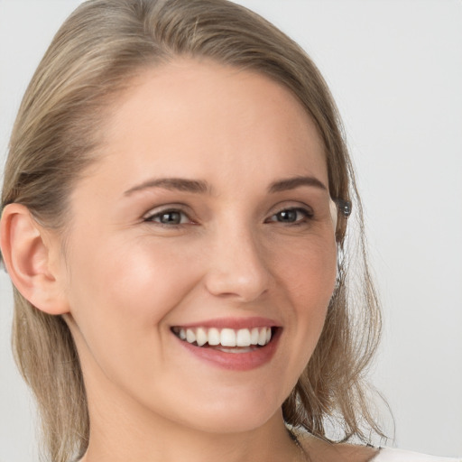 Joyful white young-adult female with long  brown hair and grey eyes