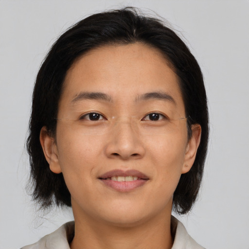 Joyful asian adult female with medium  brown hair and brown eyes