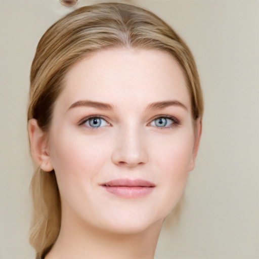 Joyful white young-adult female with long  brown hair and blue eyes