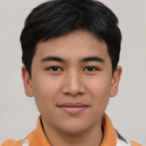 Joyful asian young-adult male with short  brown hair and brown eyes